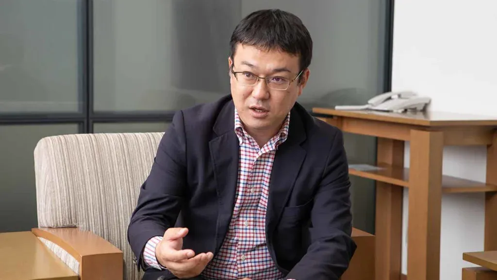 Male Toyota employee speaking and gesturing during a business interview.
